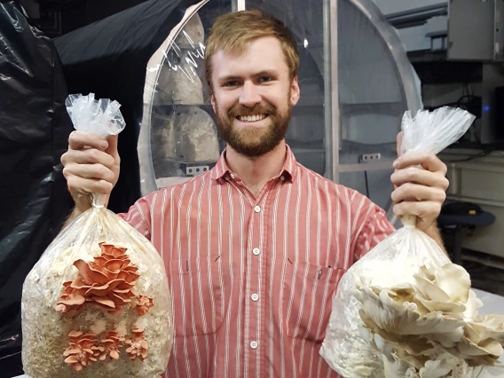 Student holding fungi