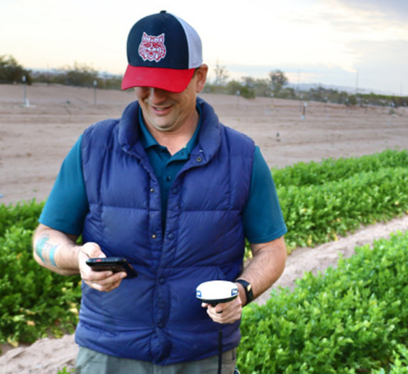 extension agent collecting readings in a field in Yuma, Arizona